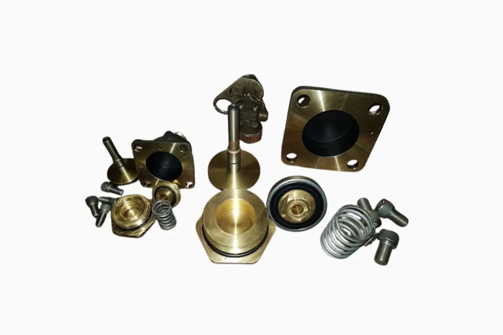 A collection of various metallic and rubber automotive parts, including valves, springs, and bolts, arranged on a white background.