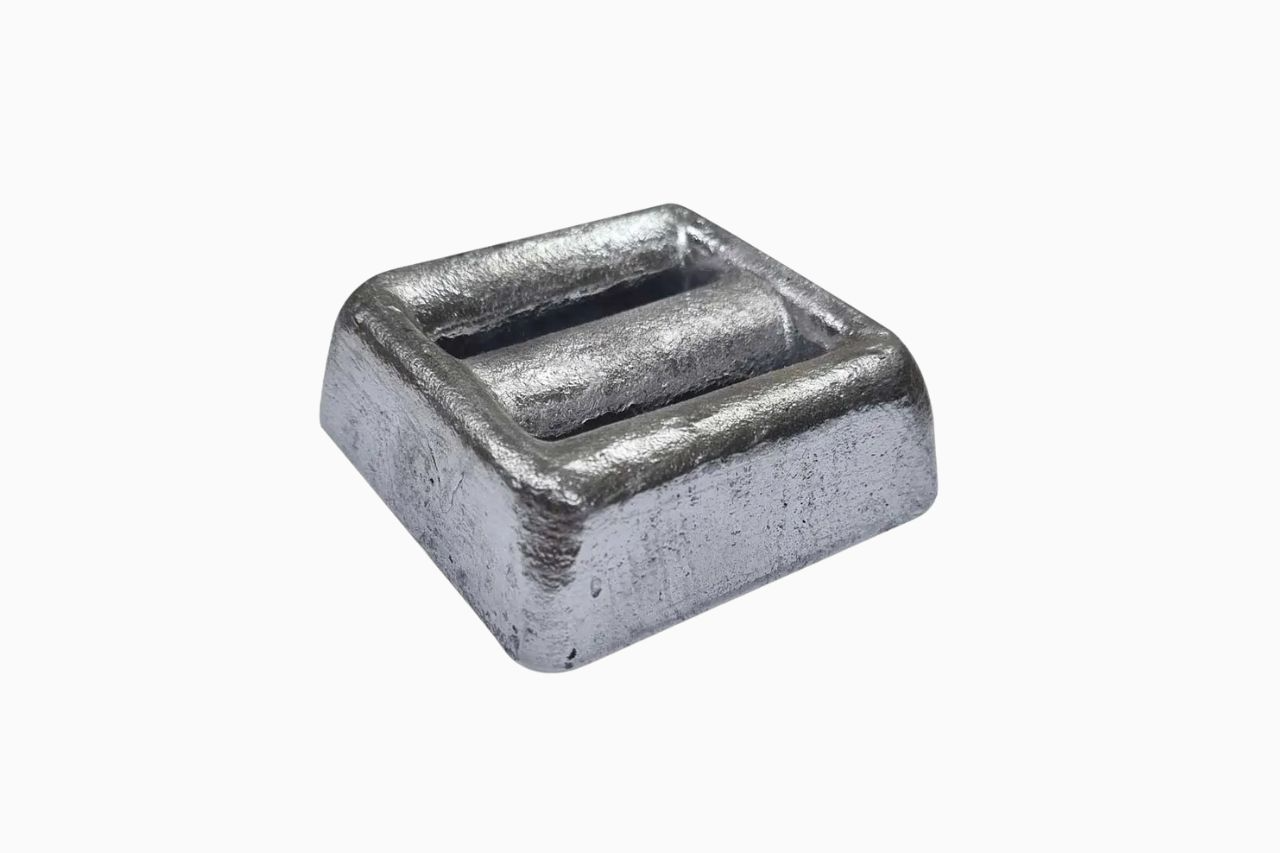 A metallic, rectangular weight with a flat top and ridged surface, designed for stability and grip.