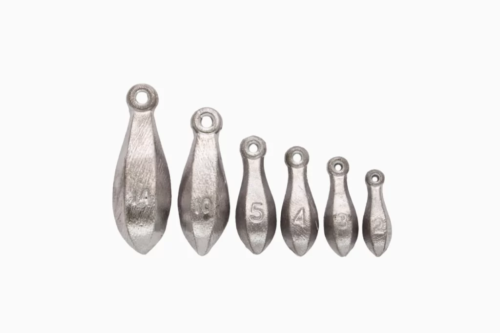 Six metal fishing weights of various sizes, shaped like teardrops, arranged in a row from largest to smallest.