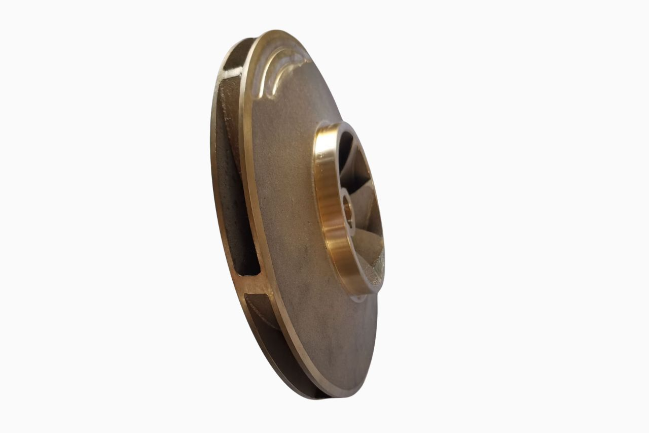 A metallic centrifugal pump impeller with curved vanes and a central opening, isolated on a white background.