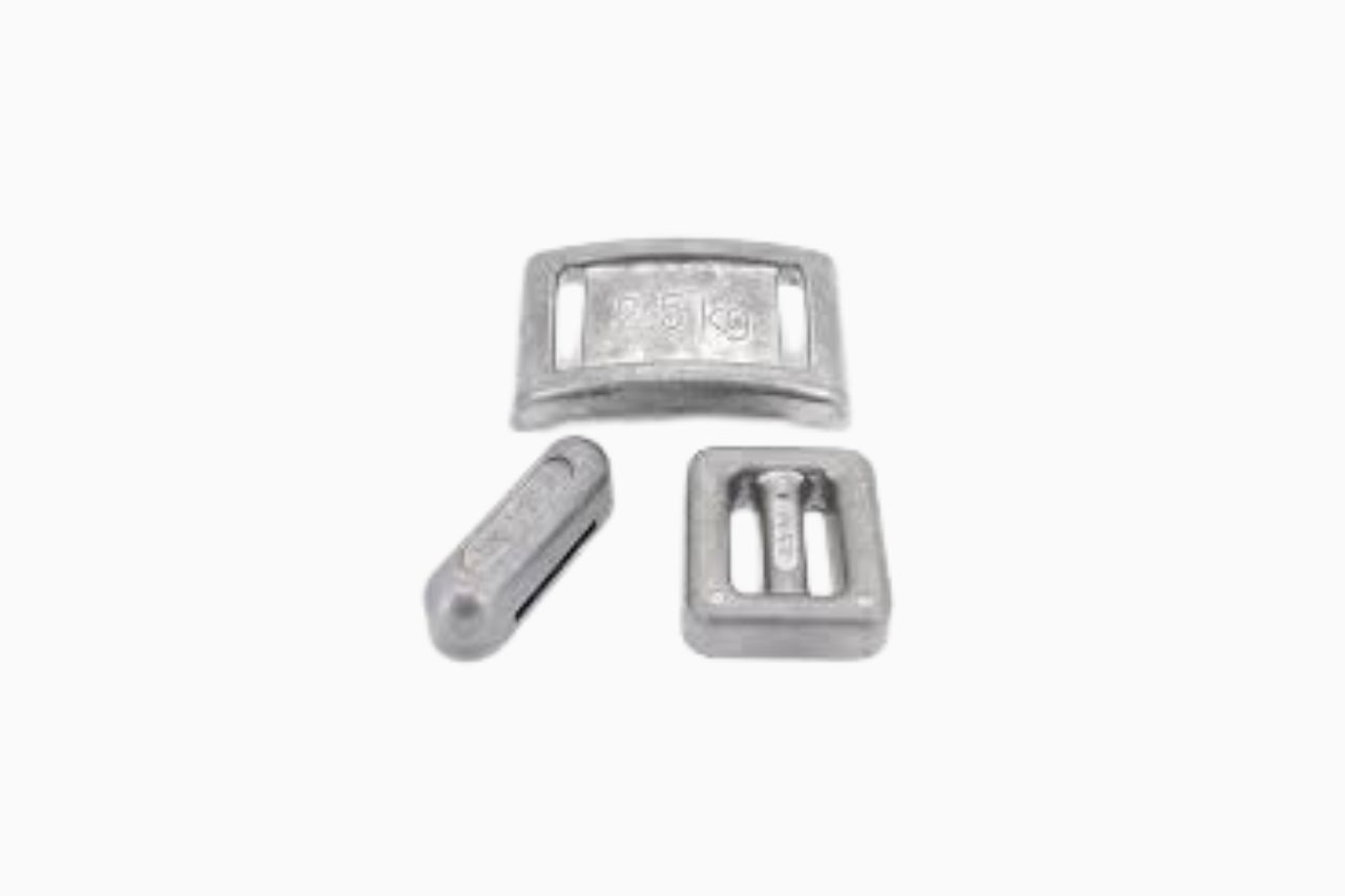 Three metal buckles in various shapes: a rectangular frame buckle, a slider, and a smaller tubular piece, all on a white background.